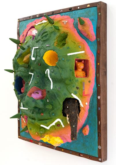 a side view of a wooly mammoth, pink animal, bell, and other objects embedded into a sculptural painting shaped like a face
