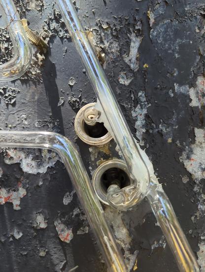 Glass Housings with Electrodes off center. Black paint chipped on the surface of the sign with clear tube "A" wired in place