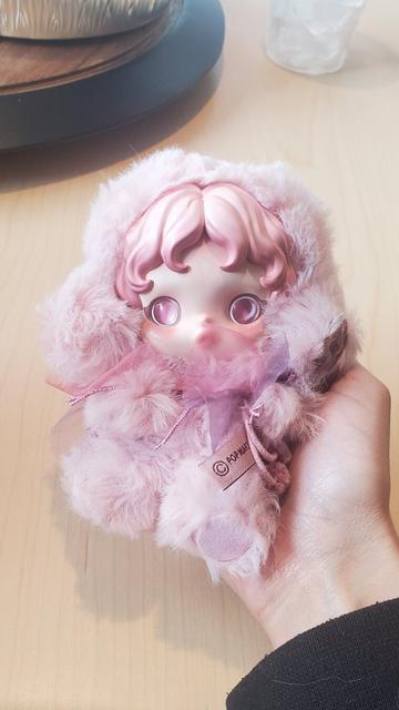skullpanda windflower charm. it is covered in a soft pink fuzzy coat with pastel pink hair and eyes