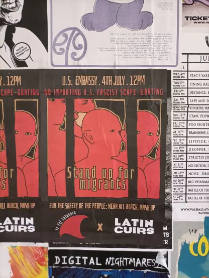 A poster with a black outline of jail bars over human figures in red expressing opposition to US and US-style immigration policy. Announces a protest outside the USA embassy on July 4. Large text reads "stand up for migrants"