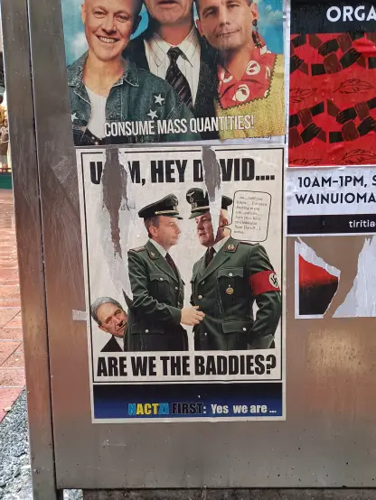 A poster depicting Christopher Luxon and David Seymour as Nazi officers, Winston Peters poking out from behind them. The text, partly scratched off, says "Umm, hey David..... Are we the baddies?"