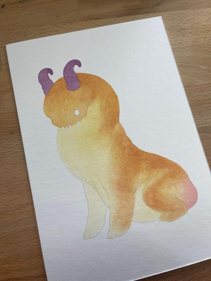 building up the colour on a watercolour painting of an orange monster with purple horns