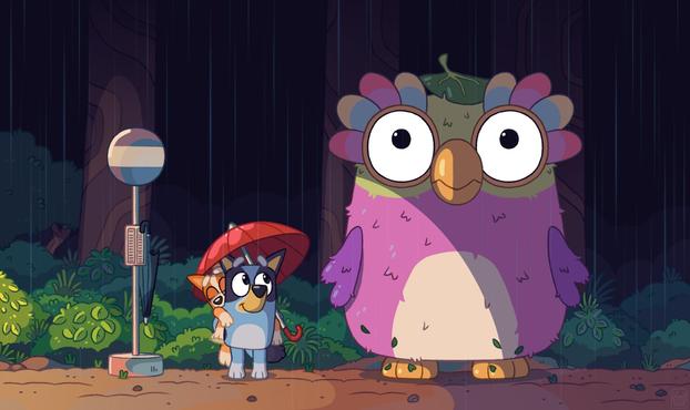 Bluey characters in the famous My Neighbor Totoro bus stop scene. Bluey has Bingo on her back, and is holding a red umbrella over both of them. Bluey is looking up at a giant Chattermax, who is staring straight ahead with large innocent eyes, and is wearing a leaf on its head