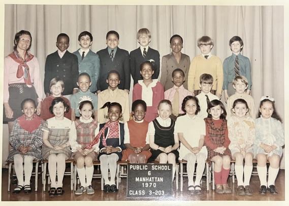A 1970 class photo of diverse young students and a teacher from Public School 6, Manhattan. Kids wear vintage clothing, smiling and seated in three rows.