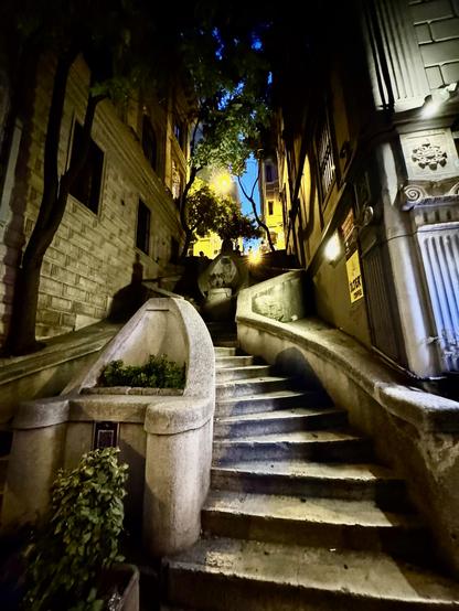 grey stone stairs up a dark passage