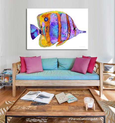 Colorful tropical fish on crisp white in a furniture setting by artist Sharon Cummings.