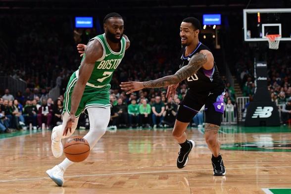 Boston Celtics wing Jaylen Brown blows past Utah Jazz big man John Collins