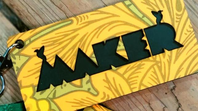 Photo of a Maker lanyard badge with black Maker writing featuring 2 liver birds (based on the badge from the first Liverpool MakeFest 10 years ago) and yellow 70s William Morris wallpaper