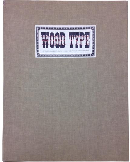 Tan cloth covered folio box with title label reading Wood Type.