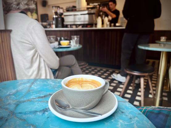 Cup of coffee on table, counter in background