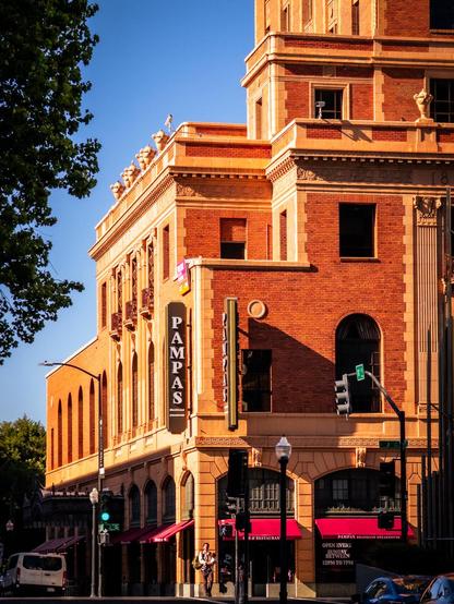 elks tower building in downtown sacramento. shot at sunset. man standing at the street corner holding a baby