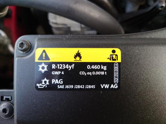 label in Golf GTI engine compartment with details of gas/oil used in airco, and warning pictograms that its hazardous, flammable and only a qualified mechanic/technician should work on it)