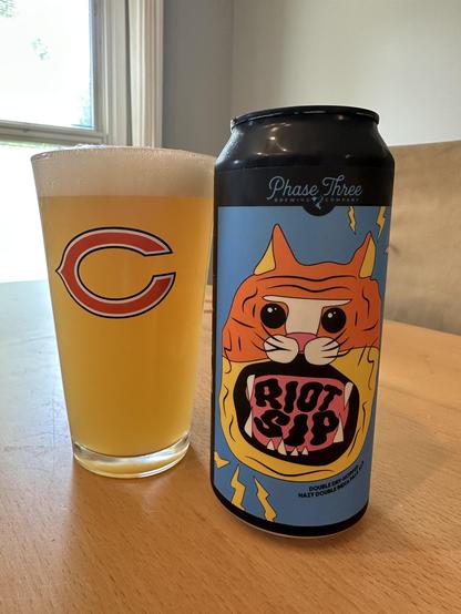Chicago bears pint glass of beer next to a can of beer by phase three called “riot sip”
