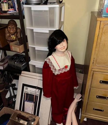 A creepy-ass life-size little girl doll in a red dress with her severed arms reaching up from the floor to be reattached (but who would dare do that?!)