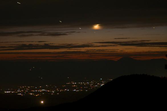 A four-ship of F-16's make short trails in these 1.6 second exposures. They are returning from night training, heading for Holloman Air Force Base.