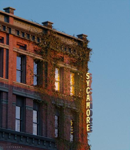 A CGI render of a red-brick hotel covered in ivy and a large lit sign that reads 'Sycamore Hotel'. The focus is on two lit windows amid the ivy.