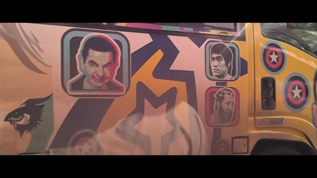 Graffiti on a bus in Nairobi, with the stylized faces of Mr Bean, Bruce Lee, a bearded dude I can't name, and one eye of what I think is Wonder Woman.