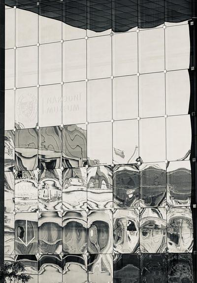 Wobbly abstract reflection in building windows of facing buildings. Prague.