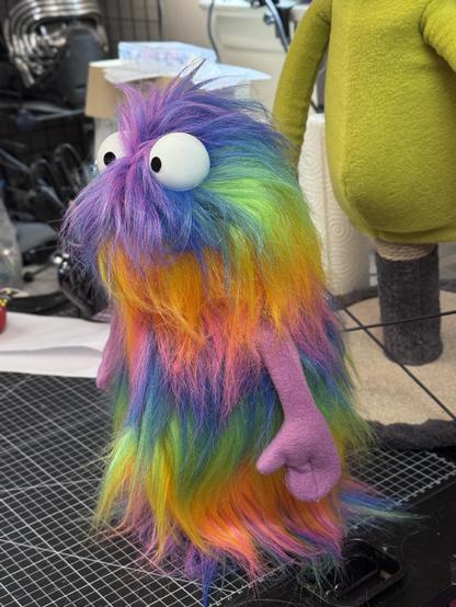A small rainbow fur hand puppet
