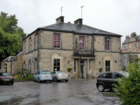 The Salisbury Arms, Edinburgh, 2015. © Copyright PAUL FARMER, CC-by-SA 2.0 via Geograph. A photo on a rainy day of a pub formed from a 3-bay, 2 storey, sandstone mansion house, with a car park out front and various outbuildings added to the side and rear.