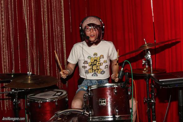 Trust Fund Ozu playing drums and singing on a headset