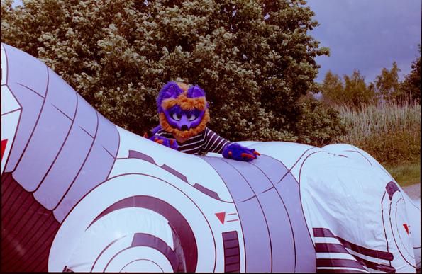 It is a purple and orange fox girl on an inflate. she is inviting you to join