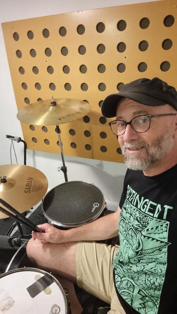 A selfie sitting at a drum kit