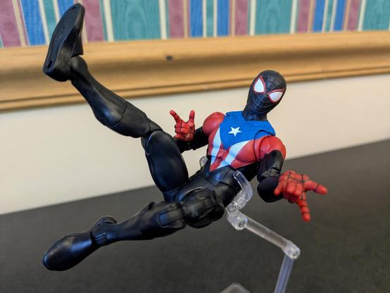 Marvel Legends Miles Morales Boricua Suit in an aerial pose with both thwip hands attached