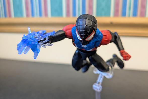 Marvel Legends Miles Morales Boricua Suit launching himself toward the viewer with his venom power charged into his right hand