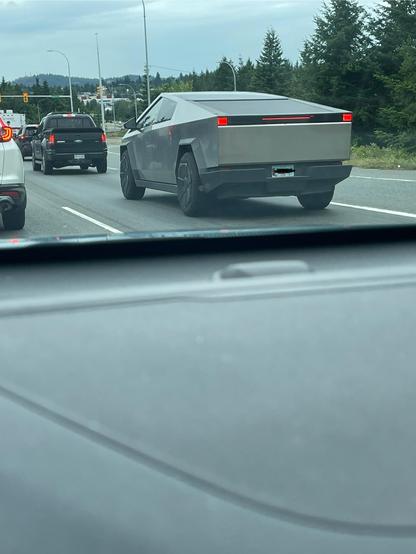 A dump truck is in front of me with a veterans license plate.