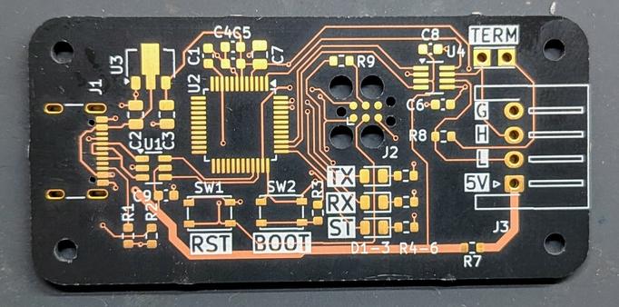 A printed circuit board in black and gold. It is rectangular and has a USB-C connector on one end, a four pin XH header on the other, and some pads for components in between.