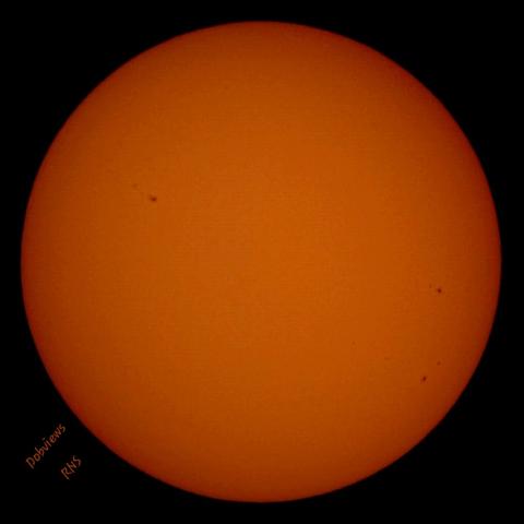 A little darker view of the Sun. Brightness cut by half. Looks like a burnt orange egg yolk.