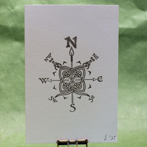 Map compass with the bodies of two stylized dragons intertwined as Celtic knots around a spear for the north-south axis and a couple arrows pointing east and west. The cardinal directions and ordinal/intercardinal directions are labeled with the appropriate abbreviations. There are pointers for the secondary intercardinal directions. The print is signed with “AC `25” in the lower right, and displayed against a green background.