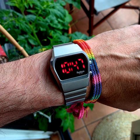 Armitron Tetra steel quartz with a retro LED design. Also on wrist is a rainbow/pride band, next to the watch.
