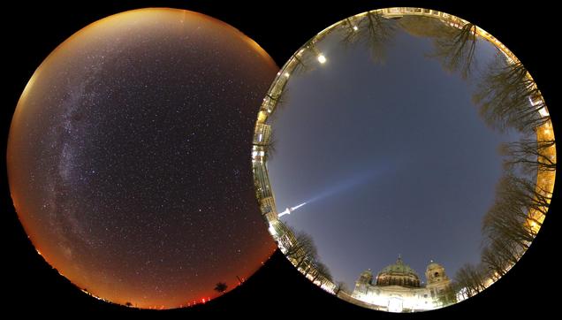 Two fisheye images of the night sky by Andreas Jechow. On the left is a location several tens of kilometers from Berlin. The sky is relatively dark overhead and you can see the Milky Way, but the horizon is still quite bright. On the right is an image taken in front of Berlin Cathedral (Berliner Dom). The sky is a bright blue-white color, and far fewer stars are visible.