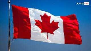 A Canadian flag flying in the breeze.