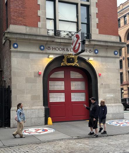 Tourists taking pictures in front of the Ghostbusters Firehouse