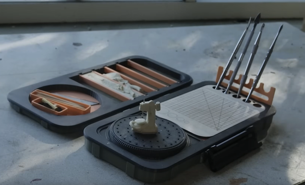 a screenshot from the video showing the kit opened up with various tools and things in use.