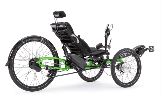 A promo photo of an Ice Adventure HD with e-assist. An example of the type of recumbent trike that might work for my mass and disabilities. It’s got two wheels in the front and one in the rear for stability. It’s a little higher off the ground than many recumbent trikes. It is viewed from slightly behind 3/4 view.