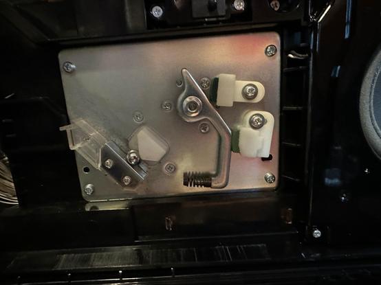 A metal arm directed at a compartment with a pachinko ball in it
