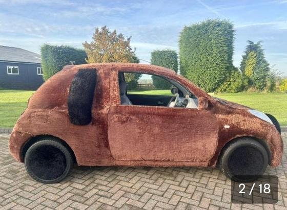 Side view of the fur covered nissan Micra showing dog ears and furry hub caps
