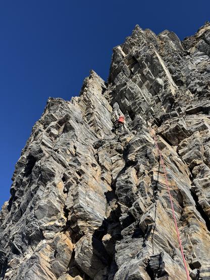 A climber in the SE ridge of Balmhorn, leading a pitch