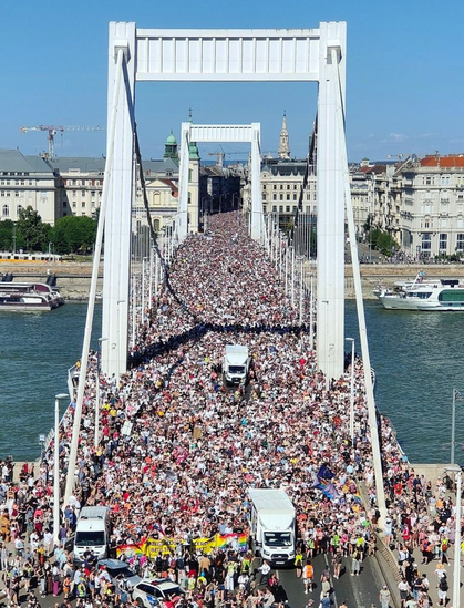 A huge crowd in Budapest today crossing a bridge a past of a Pride parade.