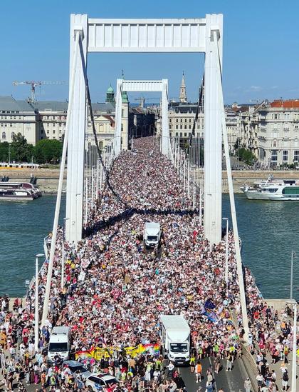 Hundreds of thousands of Pride marchers cross the Elizabeth Bridge in Budapest. The crowd carries on as far as you can see.