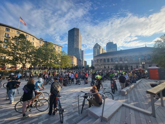 Photo of a group of several hundred cyclists gathered in Copley Square Plaza in Boston, Massachusetts