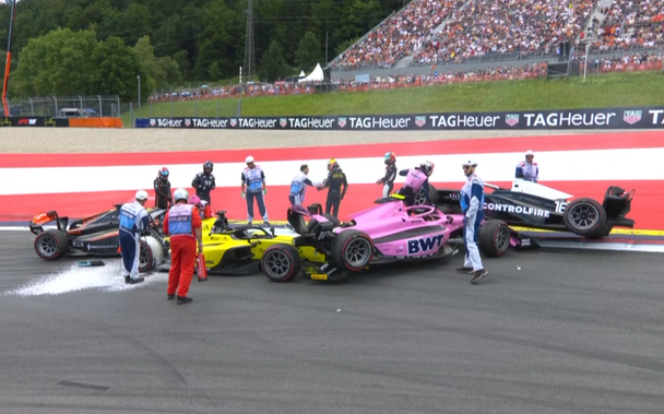 Formula 2 after-crash with 4 cars being awkwardly tangled up with each other