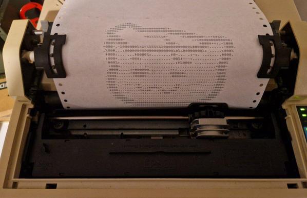 Woozy neocat is being patted - but it's ASCII art printed on a fan-fold paper on a matrix printer