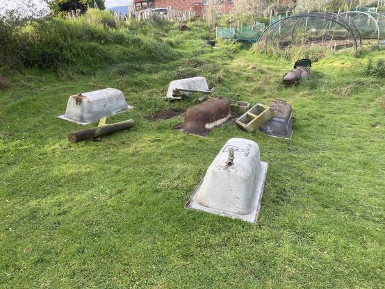 5 "antique" bathtubs dug up from various dumps and demo sites around the farm, arranged for some mysterious purpose in the lawn in our vege garden
all upside down so they don't refill with brackish waters