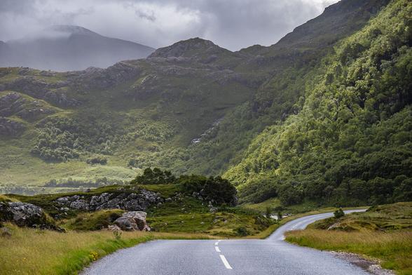 An empty road heads into the hills.