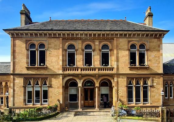 A Byzantine gothic style Victorian bathing club building made from blonde sandstone.